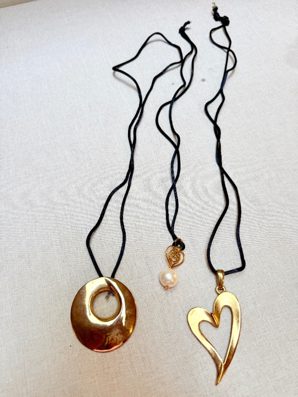 Set of 3 Gold Toned Pendant Necklaces on Black Cords